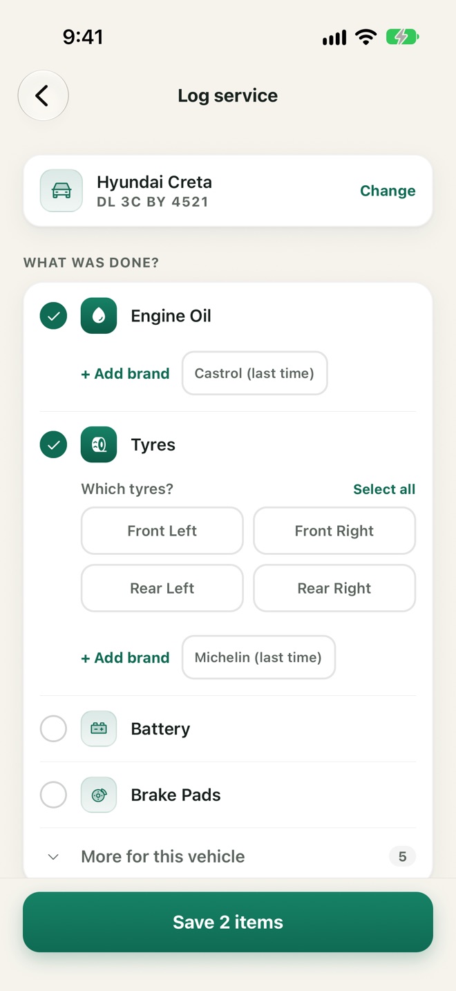 The Log service screen: Engine Oil and front tyres ticked, ready to save 2 items